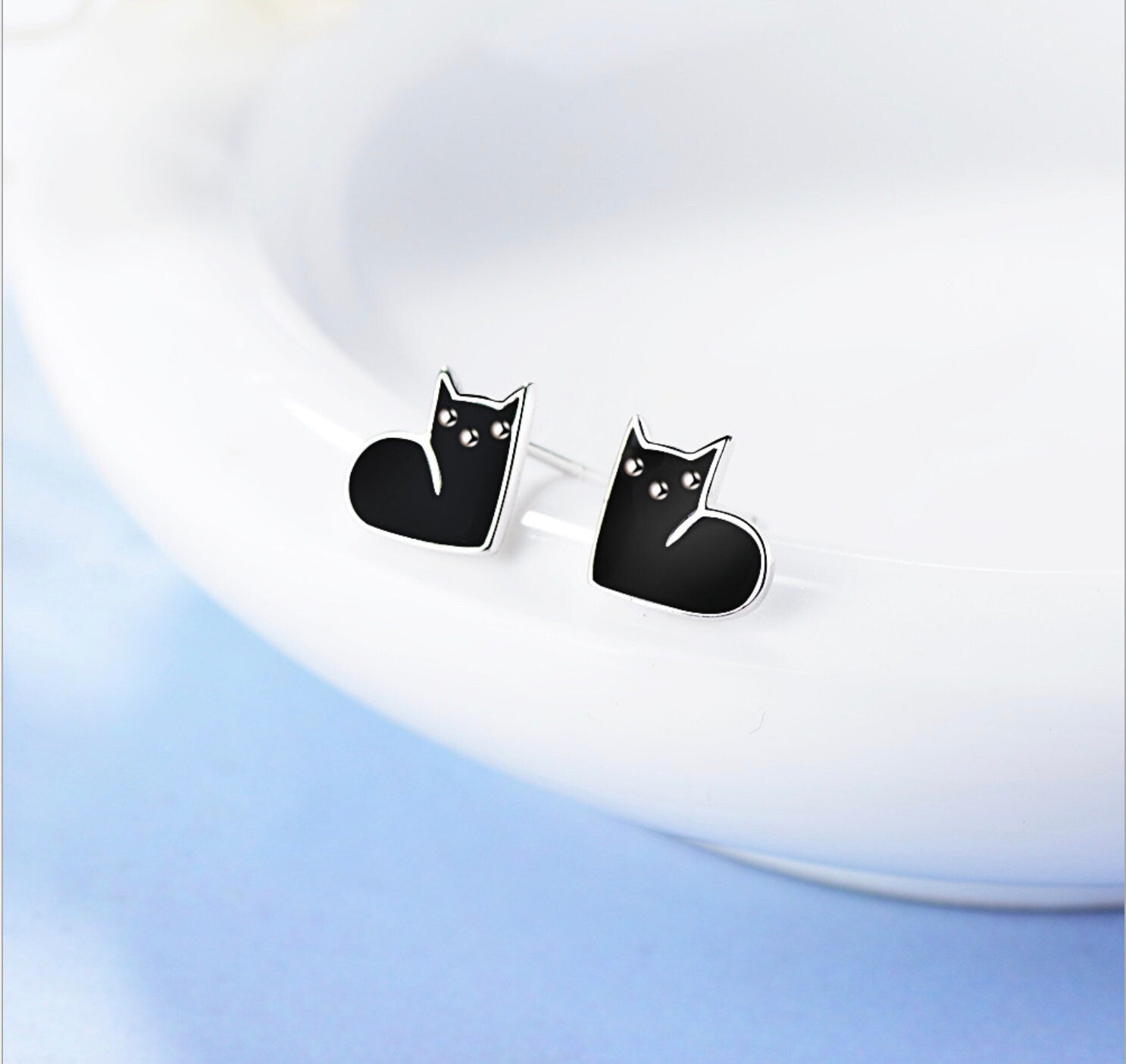 close-up of black and white cat stud earrings made of 925 sterling silver